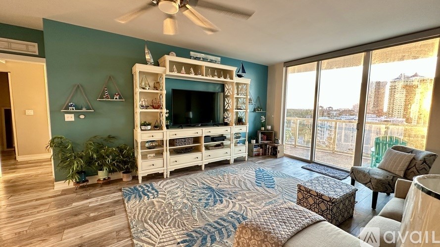 A living room with a ceiling fan and a couch.