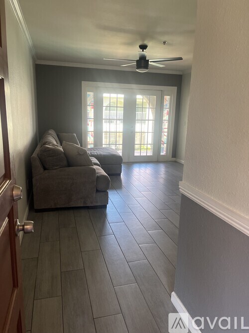 A living room with a ceiling fan and a couch.