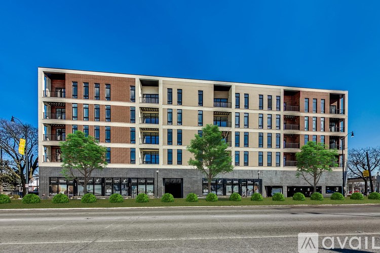 A large multi-story building with a mix of brick and panel siding.