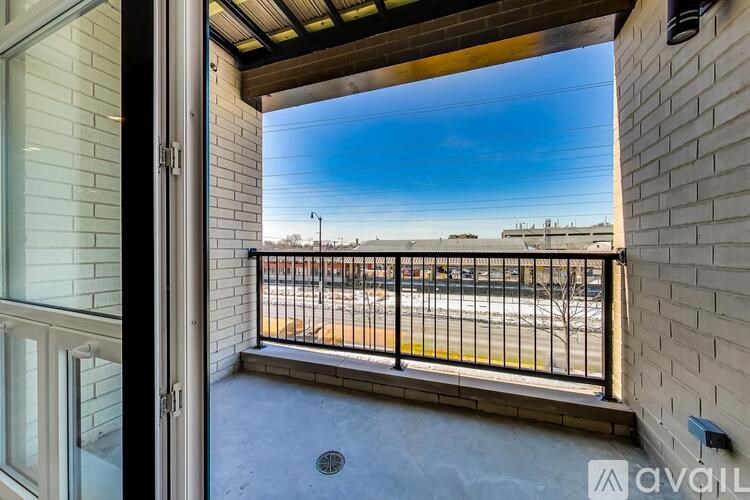 A balcony with a view of the street and buildings.