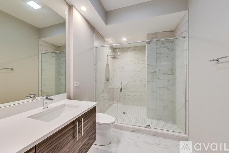 A bathroom with a marble floor and a walk-in shower.