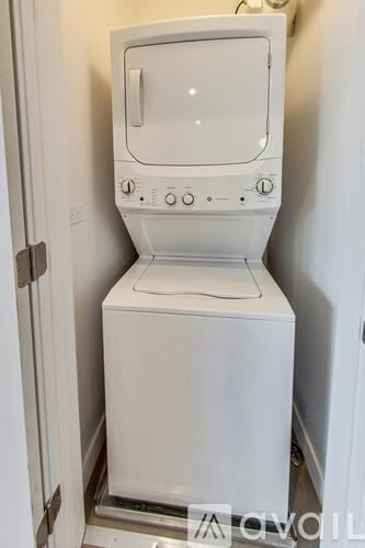 A white washing machine in a small room.