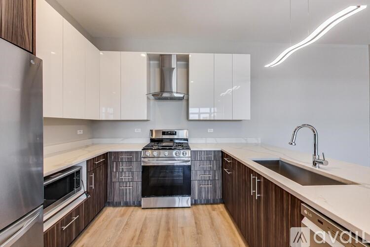 A modern kitchen with wooden cabinets and stainless steel appliances.
