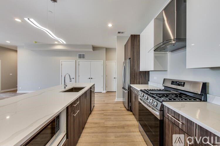 A modern kitchen with white countertops and wooden cabinets.