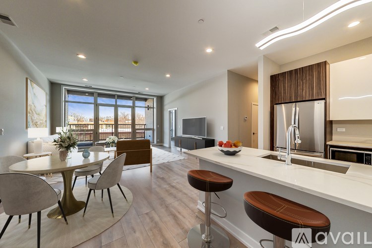 A modern kitchen with a dining table and chairs.