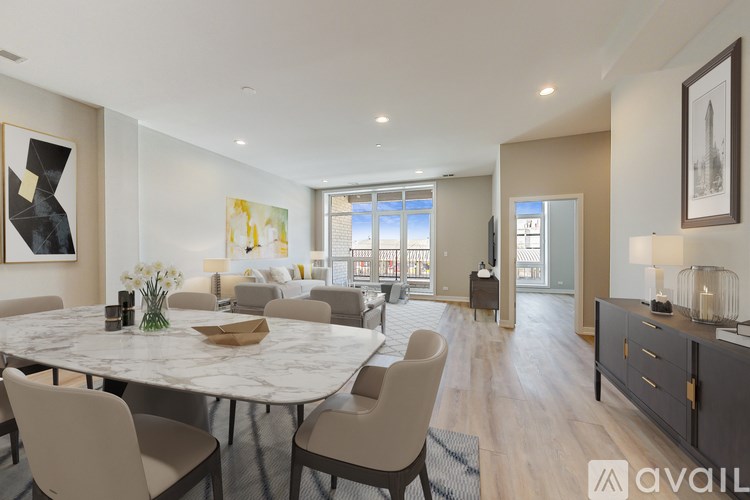 A modern dining room with a large table and chairs.