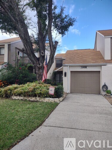 A house with a brown roof and a garage door that says "11401" on it.