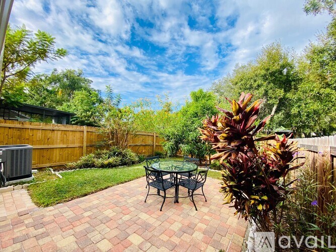 A backyard with a table and chairs.