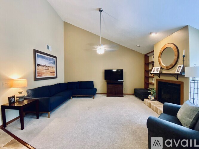A living room with a blue couch and a television.
