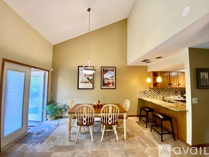 A dining room with a table set for four.