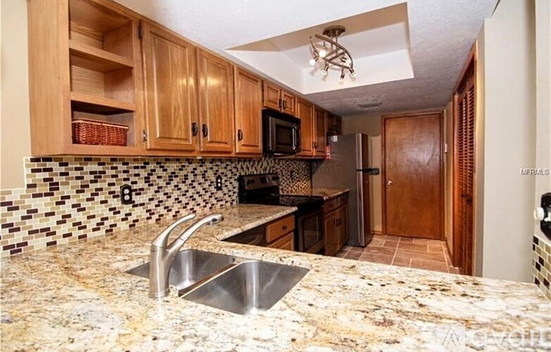 A kitchen with a sink and a counter top.