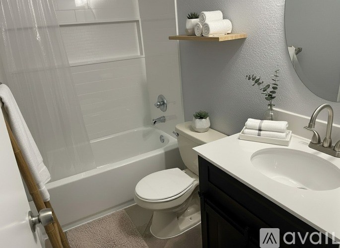 A white toilet sits next to a white sink in a bathroom.