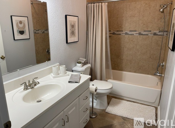 A bathroom with a sink, toilet, and bathtub.