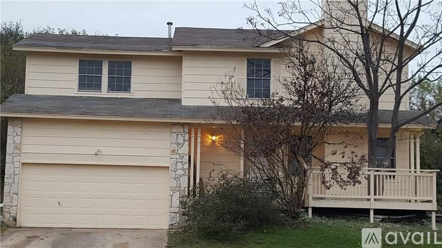 A house with a garage and a porch is available for sale.