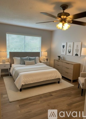A bedroom with a bed, nightstand, and a ceiling fan.