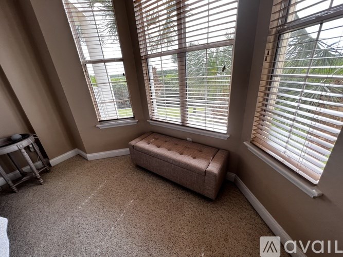 A room with a window and a bench.