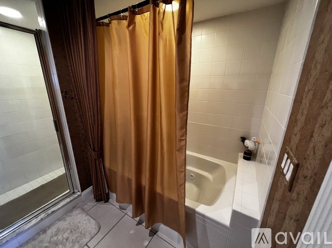 A bathroom with a shower curtain and a bathtub.