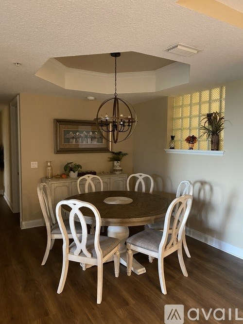A dining room with a round table and chairs.