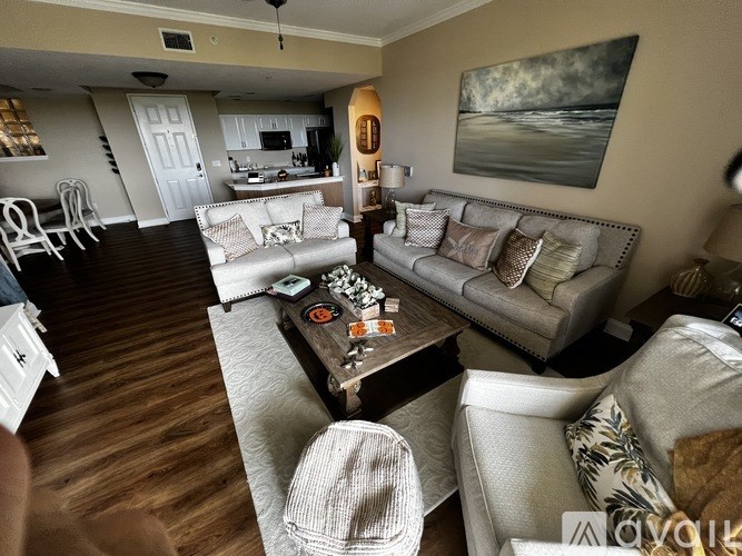 A living room with a grey couch and a coffee table.