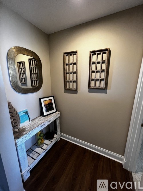 A room with a white shelf and two windows.