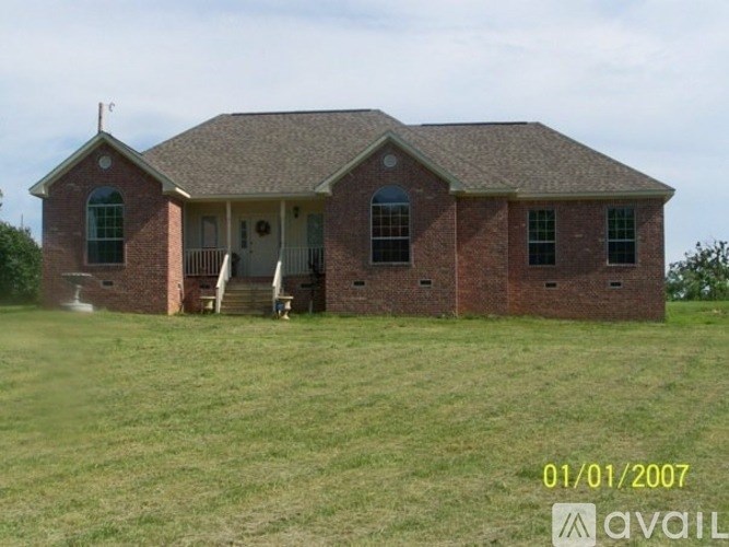 A house with a brown roof and a white door is shown.