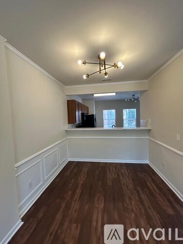 A room with wooden floors and a chandelier.