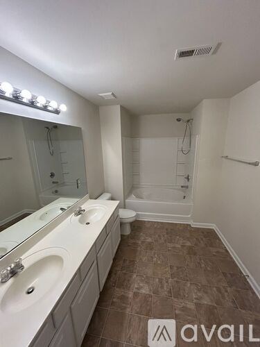 A bathroom with brown tiles and a white sink.