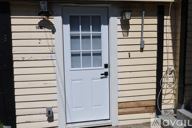 A white door with a window above it is on a house.