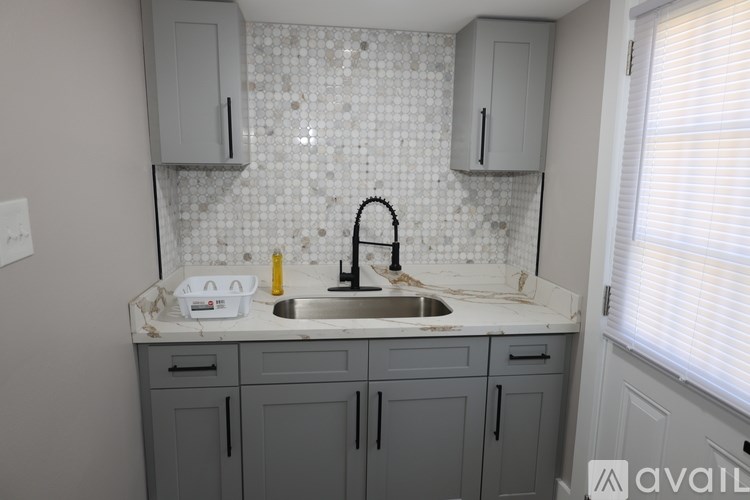 A kitchen with a sink and cabinets.
