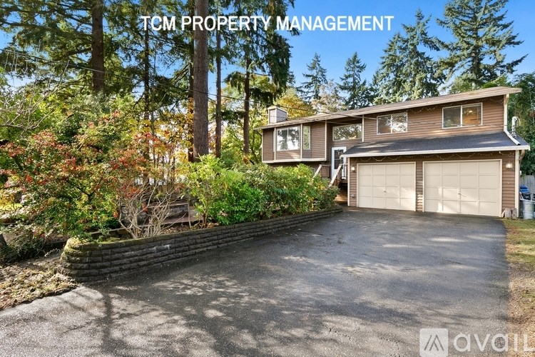 A house with a driveway and garage is for sale through TCM Property Management.
