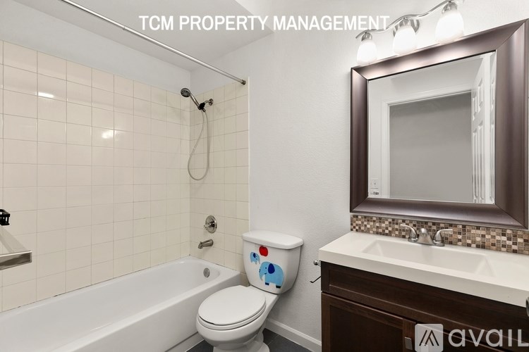 A bathroom with a toilet, sink, and bathtub.