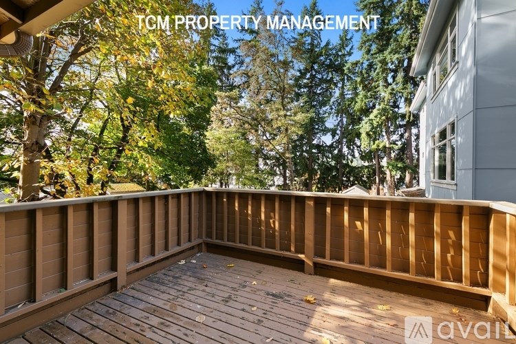 A wooden deck with a railing is shown in the image.