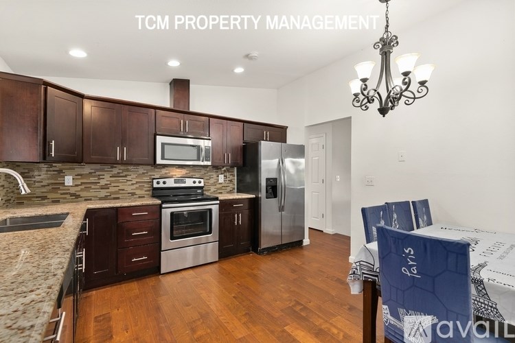 A kitchen with brown cabinets and a stove top oven.