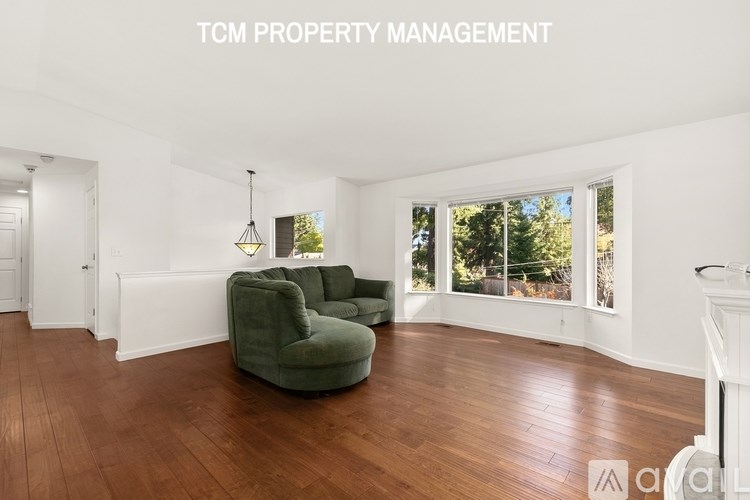 A living room with a green chair and a fireplace.