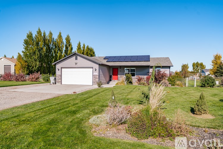 A house with a garage and solar panels on the roof.