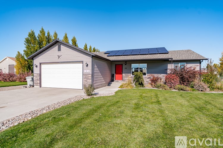 A house with a garage and solar panels on the roof.