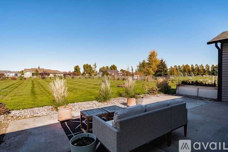 A backyard with a hot tub and a bench.