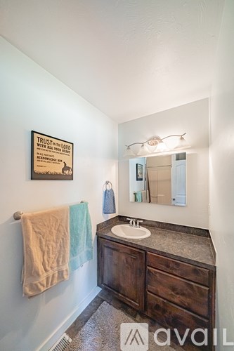 A bathroom with a poster on the wall that says "Trust in God".