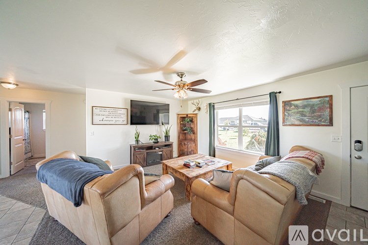 A living room with two tan couches and a coffee table.