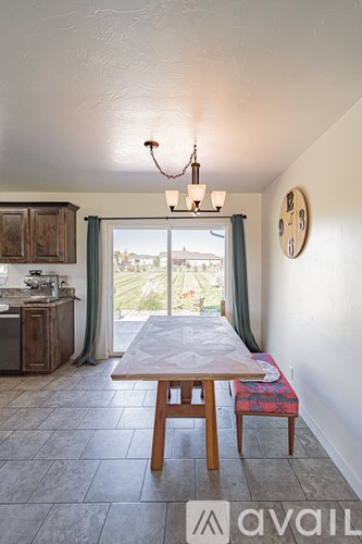 A dining room with a table and chairs.
