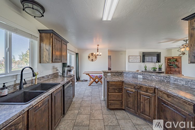 A kitchen with wooden cabinets and granite countertops.