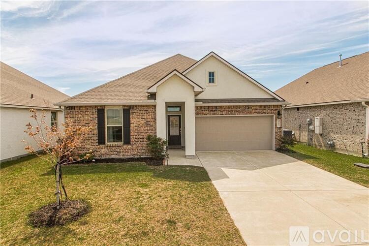 A house with a garage and a driveway is available for sale.