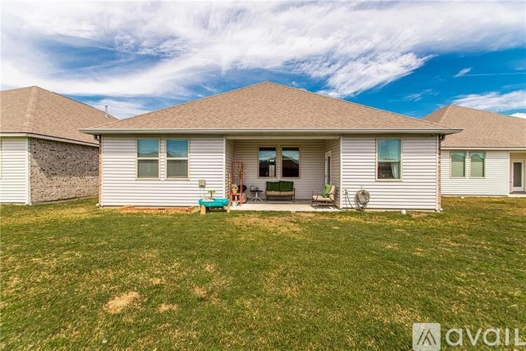 A house with a brown roof and a white exterior is shown.