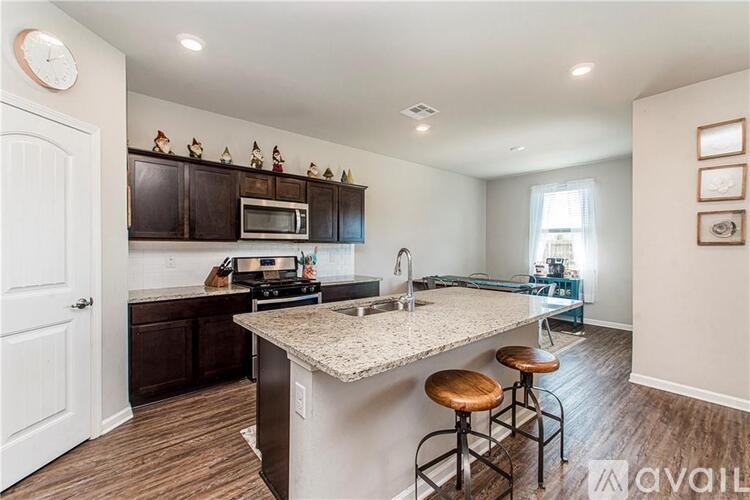 A kitchen with a bar stool and a countertop.