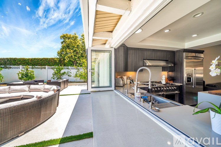 A modern kitchen with a view of the outdoors.