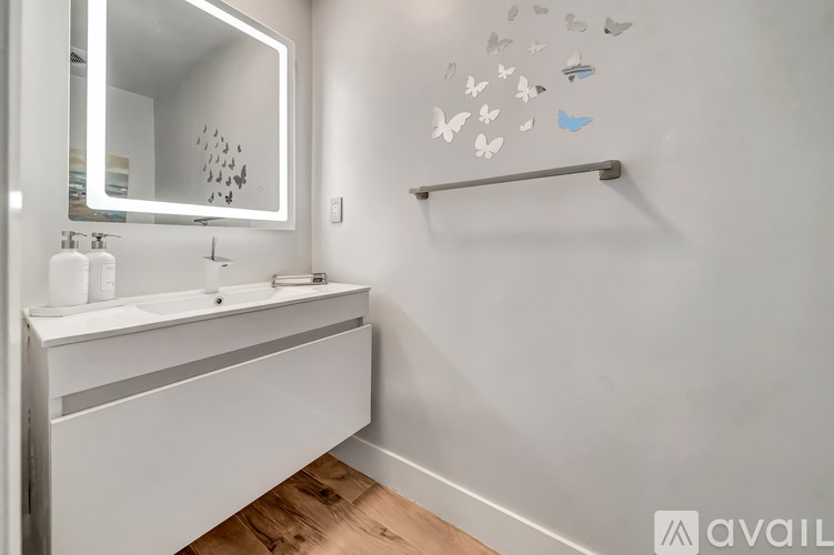 A bathroom with a white sink and a mirror.