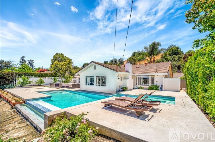 A house with a pool in the backyard.