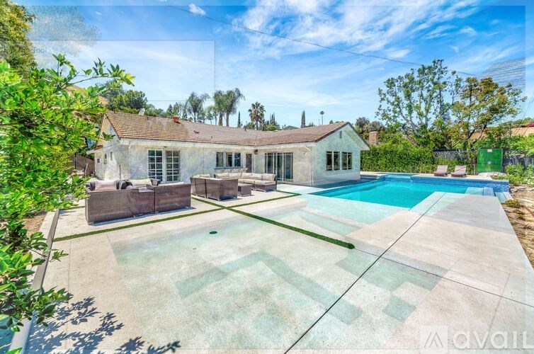 A house with a pool in the backyard.