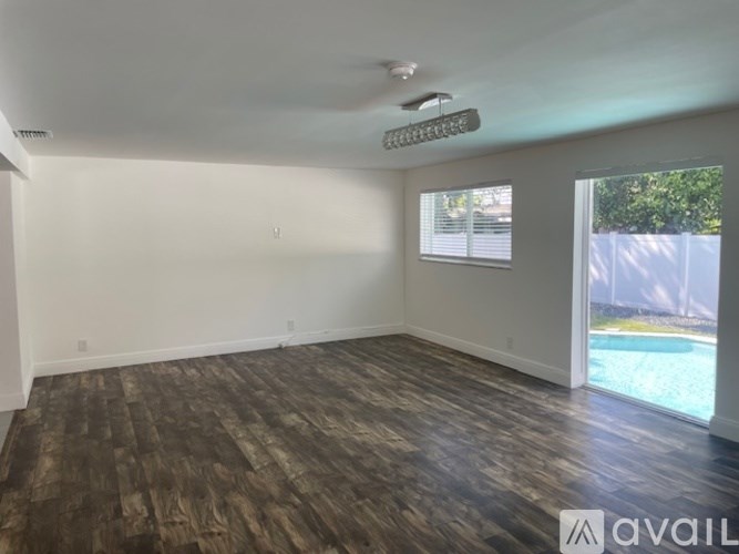 A room with wooden flooring and a ceiling fan.