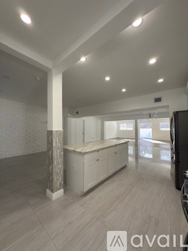 A spacious kitchen with a countertop and cabinets.